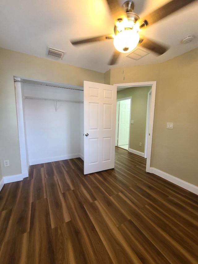 unfurnished bedroom featuring a closet, ceiling fan, and dark hardwood / wood-style flooring