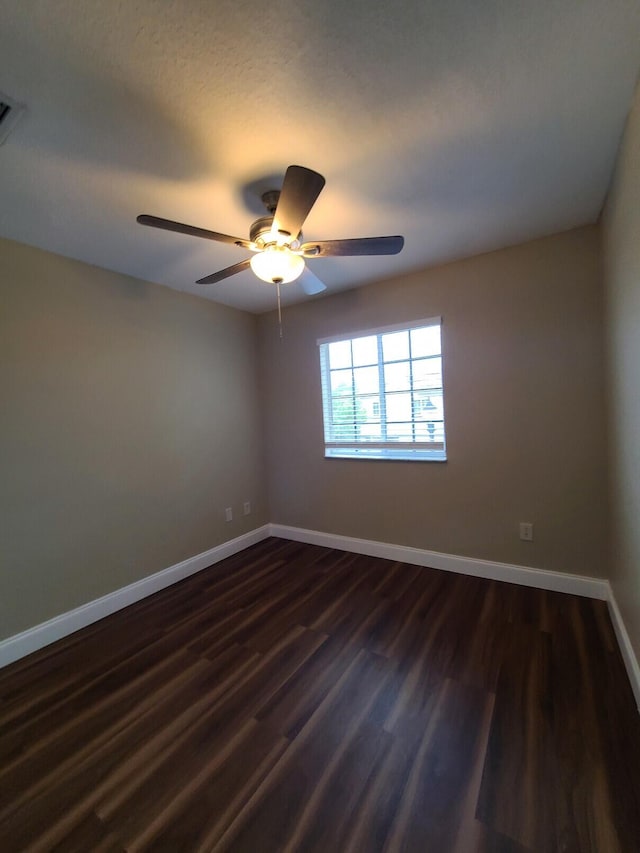 empty room featuring dark hardwood / wood-style floors and ceiling fan