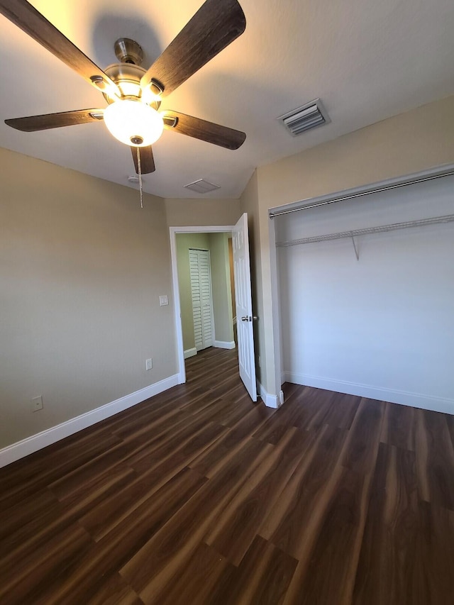 unfurnished bedroom with a closet, ceiling fan, and dark hardwood / wood-style floors