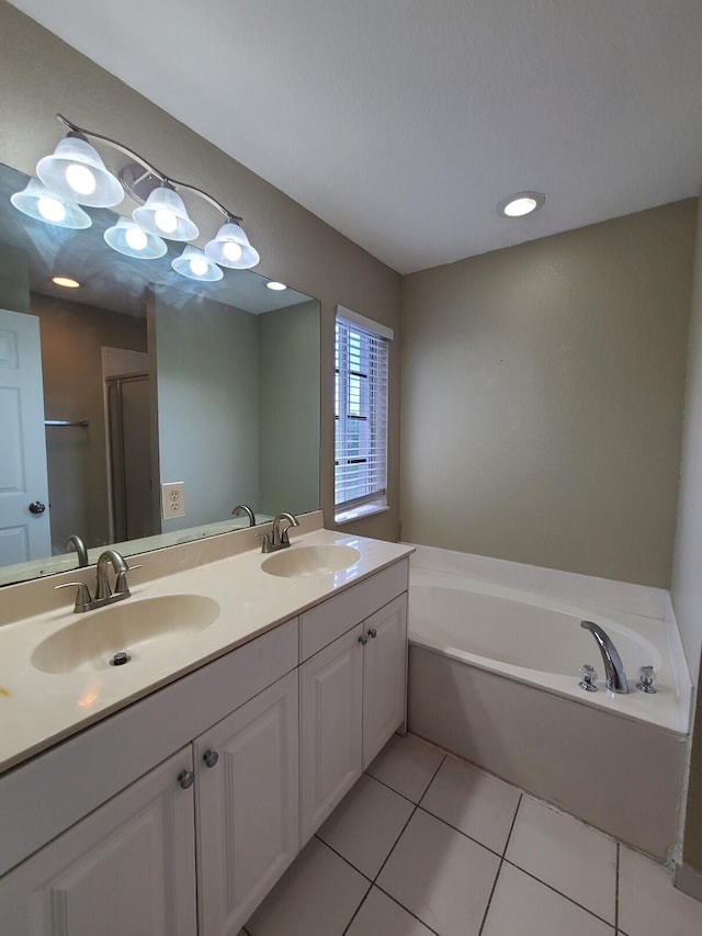 bathroom featuring vanity, a tub, and tile patterned flooring