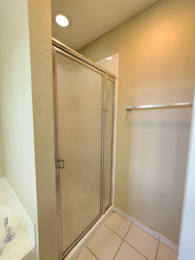 bathroom featuring tile patterned floors and an enclosed shower