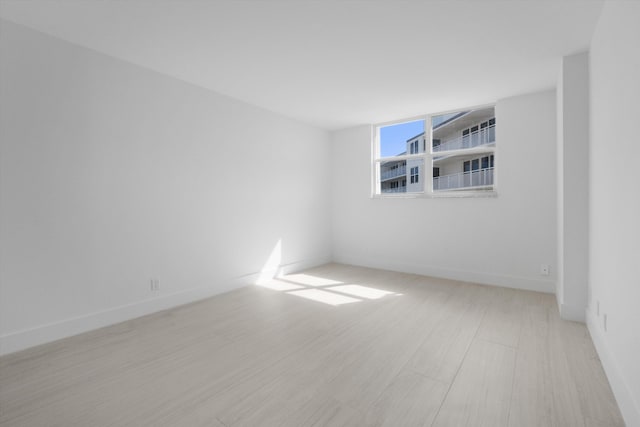 unfurnished room with light wood-type flooring