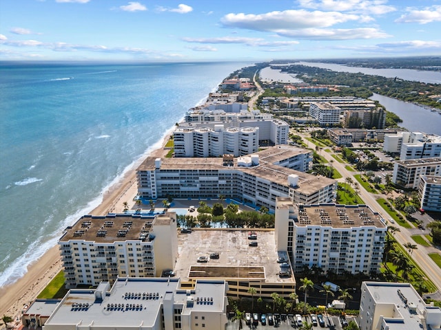 aerial view with a water view and a beach view