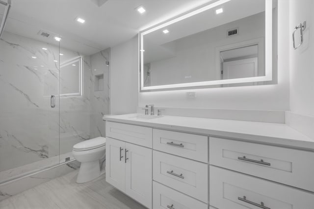 bathroom featuring vanity, toilet, and walk in shower