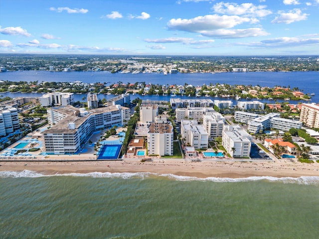 birds eye view of property featuring a water view and a beach view