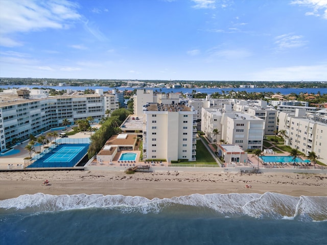 birds eye view of property featuring a water view and a beach view