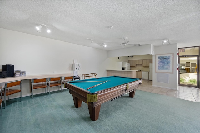 rec room with a textured ceiling, pool table, carpet flooring, and ceiling fan