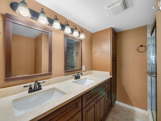 bathroom featuring vanity, an enclosed shower, and tile patterned floors