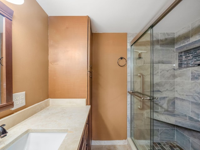 bathroom featuring vanity and an enclosed shower