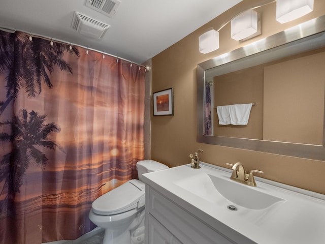 bathroom featuring toilet, curtained shower, and vanity