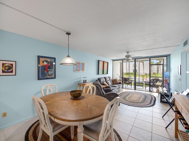 tiled dining space featuring a textured ceiling and ceiling fan