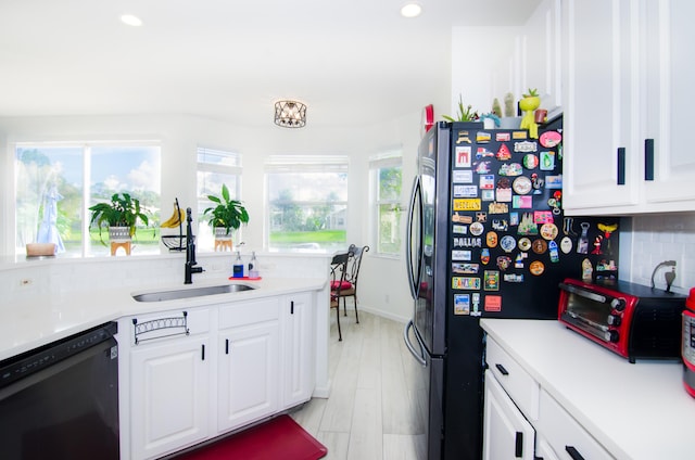 kitchen featuring white cabinetry, sink, backsplash, and dishwasher