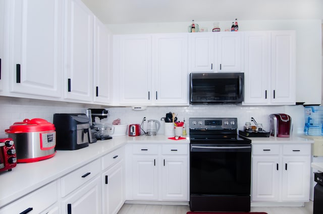 kitchen featuring backsplash, white cabinetry, and black appliances