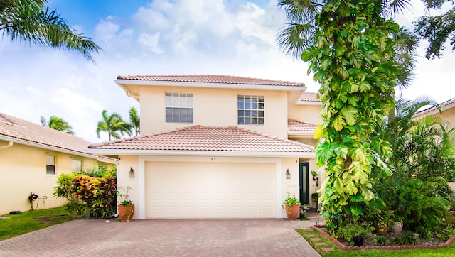 mediterranean / spanish-style home with a garage