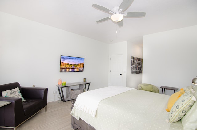 bedroom with light hardwood / wood-style floors and ceiling fan