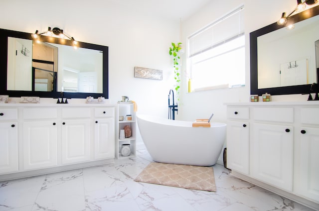 bathroom featuring vanity and a tub to relax in