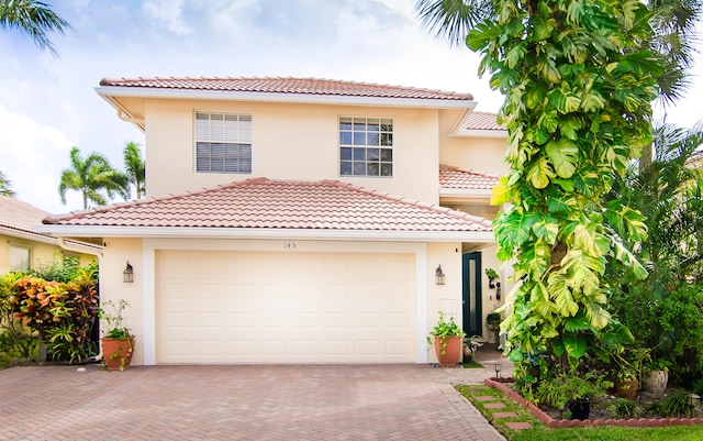 mediterranean / spanish-style home with a garage