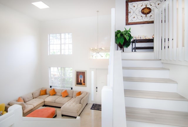 staircase with a wealth of natural light and a chandelier