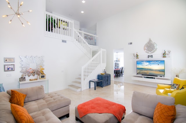 living room featuring a towering ceiling and an inviting chandelier