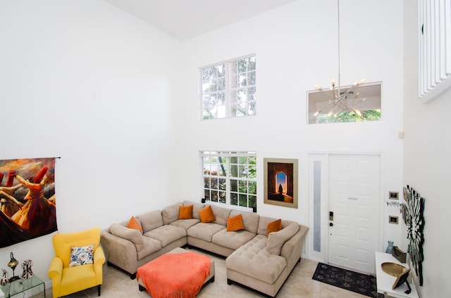 tiled living room with a high ceiling and an inviting chandelier