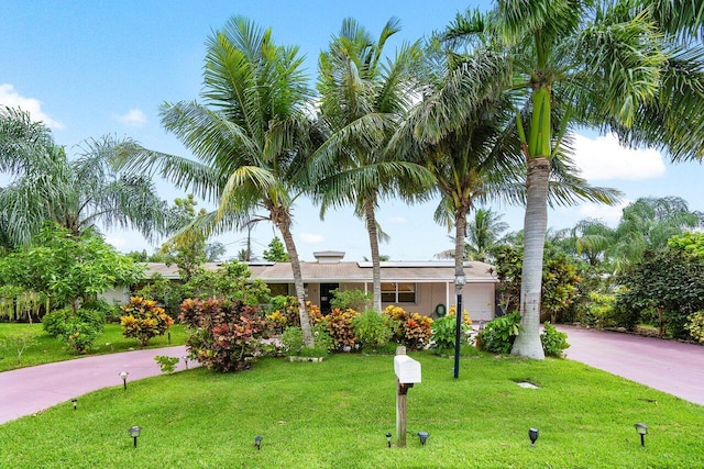 view of front of home with a front lawn and a garage