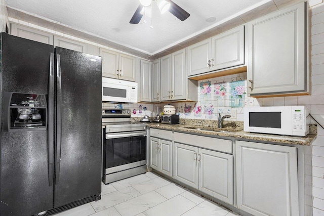 kitchen featuring sink, tasteful backsplash, electric range, and black fridge