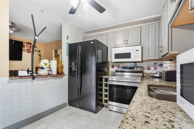 kitchen featuring gray cabinetry, a textured ceiling, electric range, and black fridge