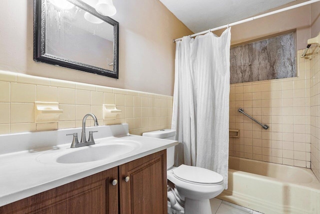 full bathroom with vanity, shower / bath combo with shower curtain, toilet, and tile walls