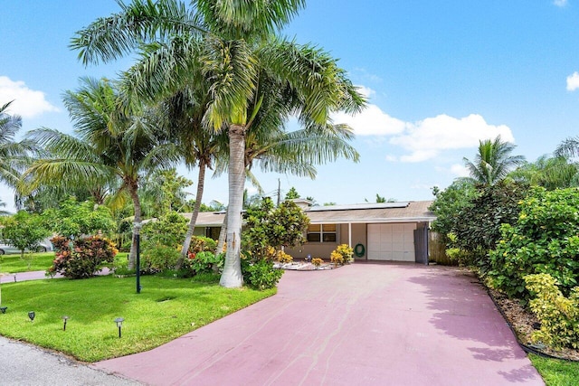 view of front of house featuring a front yard and a garage