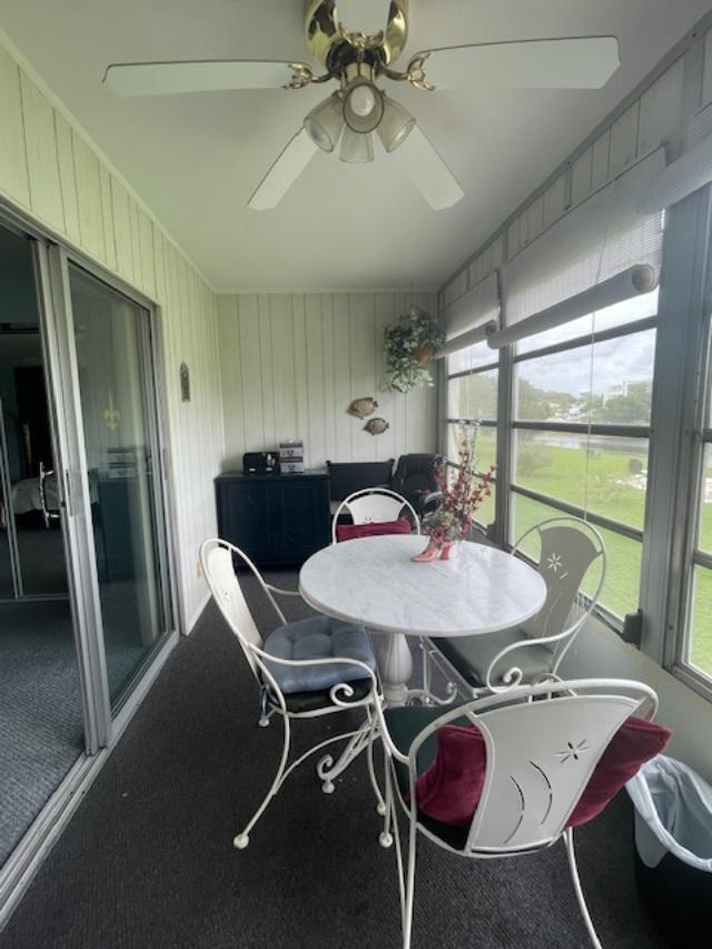 sunroom / solarium with ceiling fan