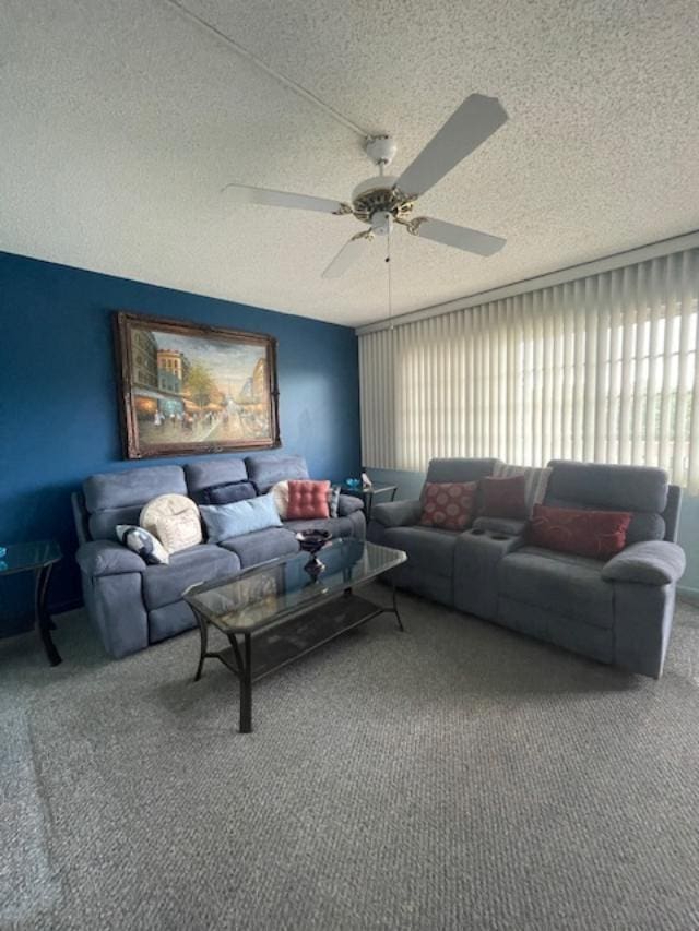 living room with carpet, a textured ceiling, and ceiling fan