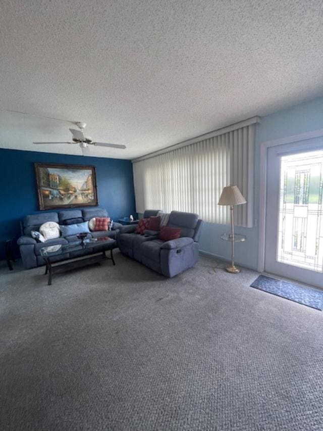 carpeted living room featuring a textured ceiling and ceiling fan