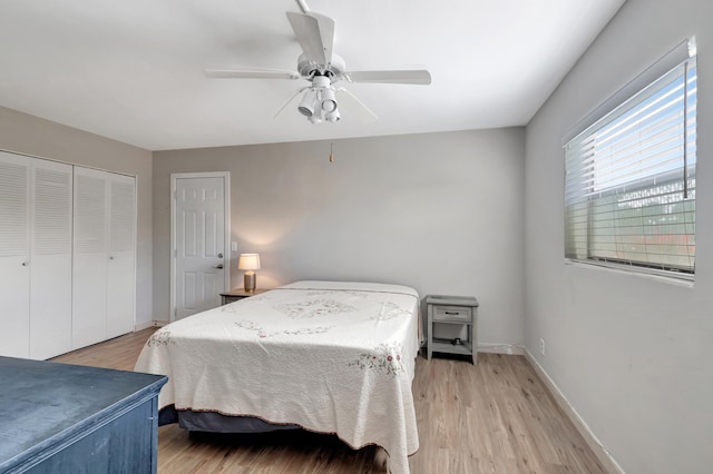 bedroom featuring light hardwood / wood-style flooring, a closet, and ceiling fan