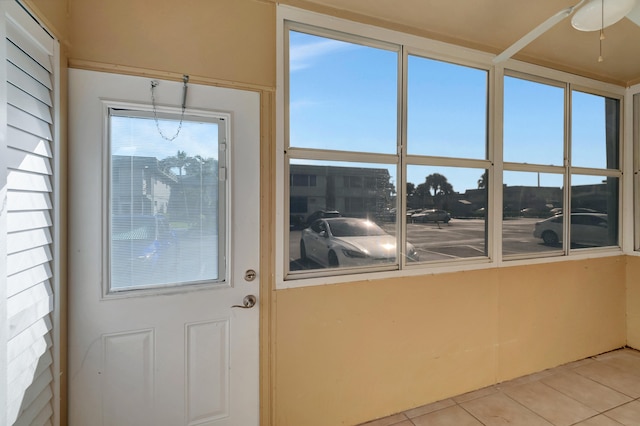 interior space with light tile patterned flooring and ceiling fan