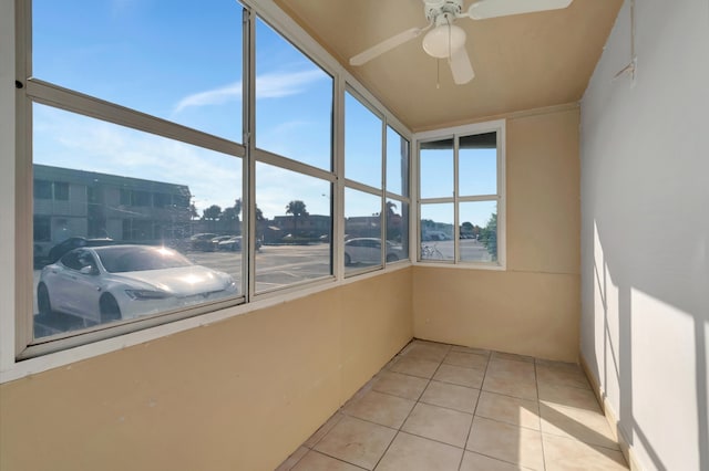 unfurnished sunroom with ceiling fan and plenty of natural light