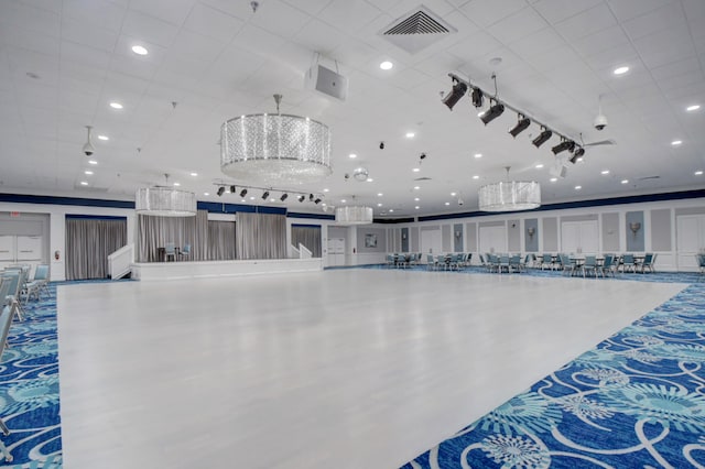 miscellaneous room with an inviting chandelier