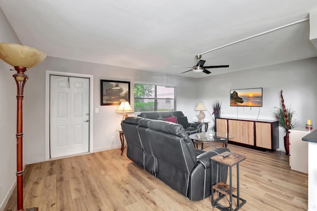 living room featuring light hardwood / wood-style flooring and ceiling fan