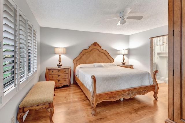 bedroom featuring ceiling fan, a textured ceiling, and light hardwood / wood-style flooring