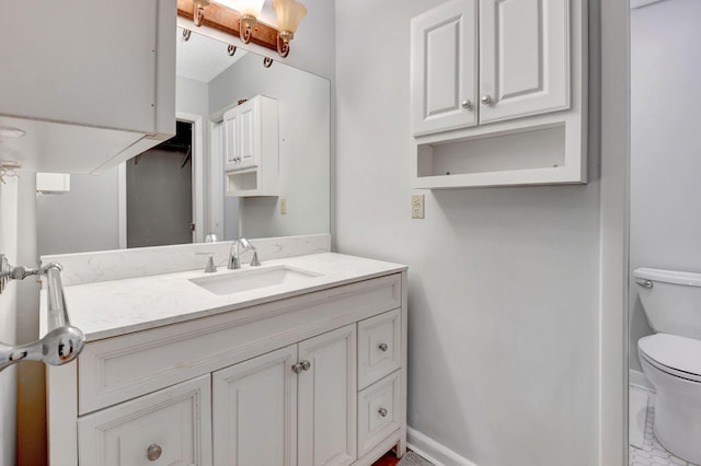 bathroom featuring vanity and toilet