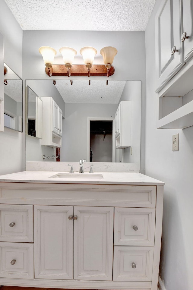 bathroom featuring vanity and a textured ceiling