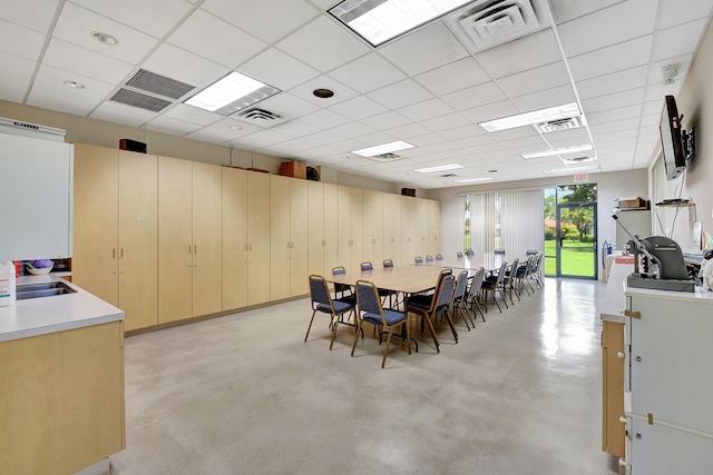 dining space featuring a paneled ceiling and sink