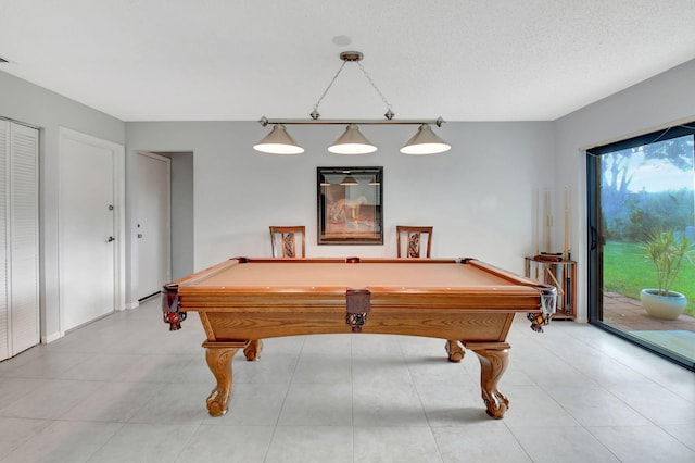 playroom with a textured ceiling and billiards