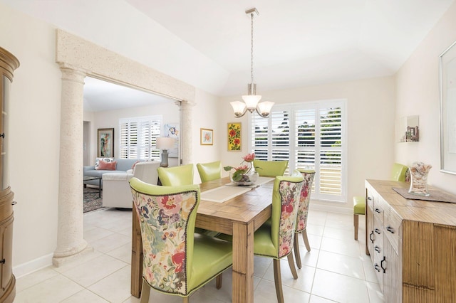 tiled dining space featuring a notable chandelier and decorative columns