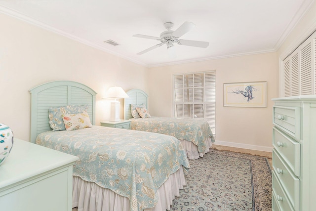 bedroom with ceiling fan and crown molding