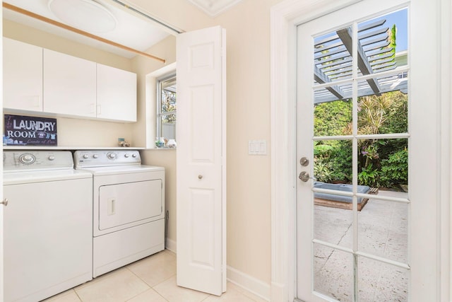 laundry room with cabinets, plenty of natural light, ornamental molding, and washing machine and clothes dryer