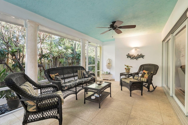 sunroom / solarium with ornate columns and ceiling fan