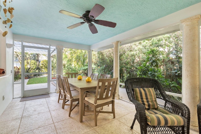 sunroom / solarium with decorative columns and ceiling fan