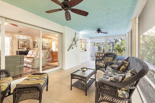 sunroom featuring ceiling fan