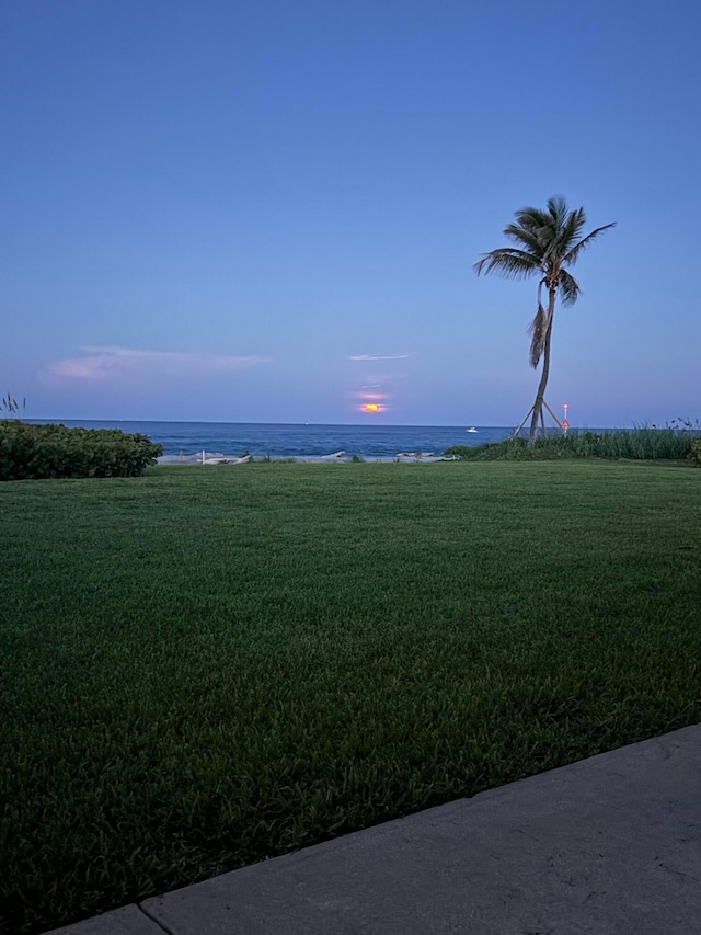 yard at dusk with a water view