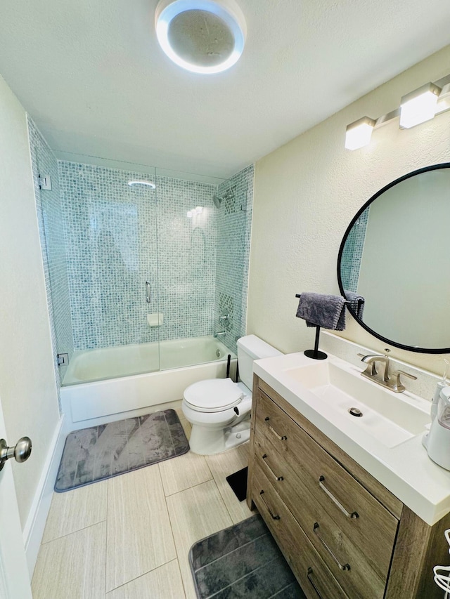 full bathroom featuring tiled shower / bath, vanity, and toilet